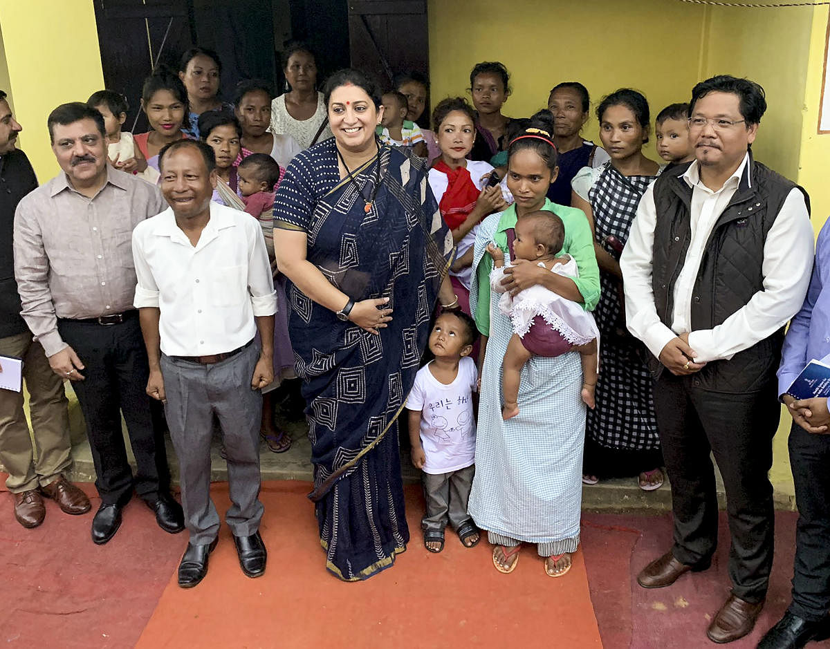 Women and Child Development (WCD) Minister Smriti Irani with Meghalaya Chief Minister Conrad Sangma visits 'Umdihar Anganwadi Centre' to oversee the implementation of 'Poshan Abhiyaan', which aims to bring down stunting of children in the age group of 0-6 years from 38.4 per cent to 25 per cent by 2022. (PTI Photo)