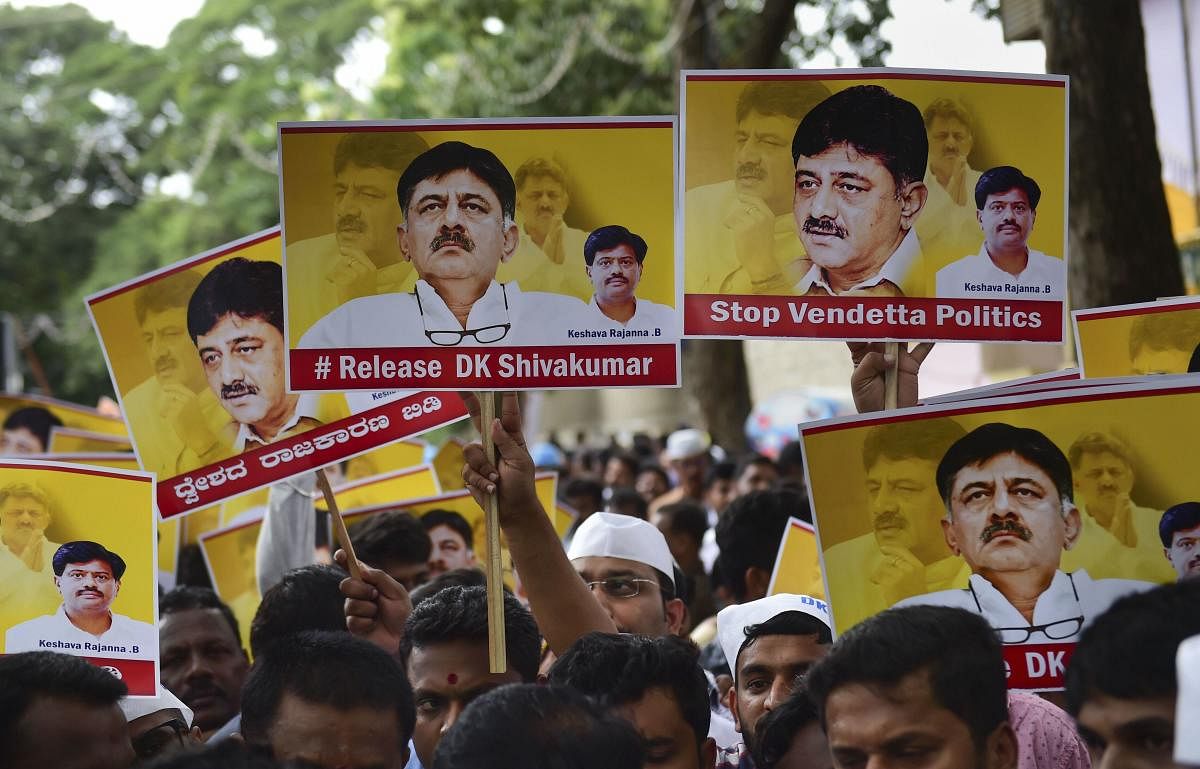 Vokkaliga community members hold posters during a protest against the arrest of Congress leader DK Shivakumar in a money laundering case in Bengaluru. PTI Photo