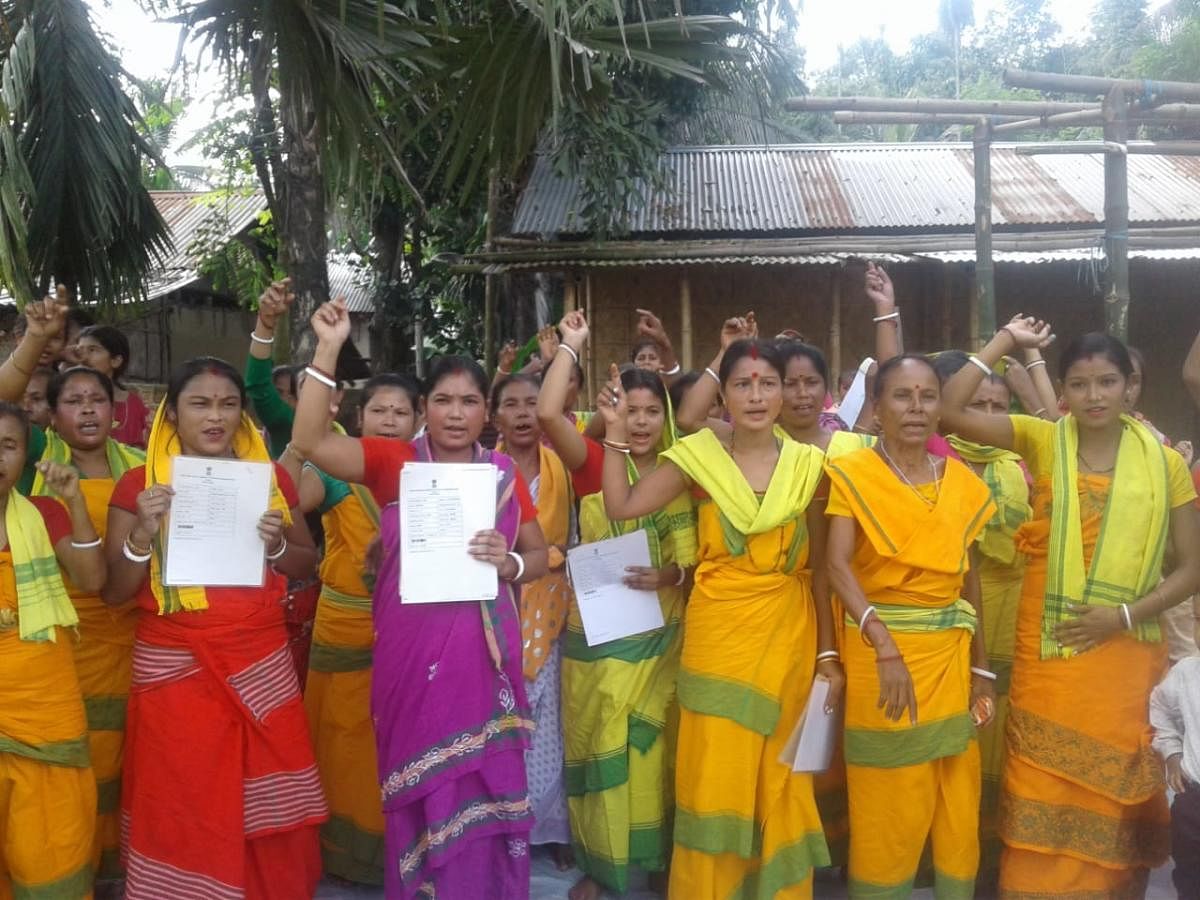 Women belonging to Koch Rajbongshi community staging a protest against exclusion of their names from NRC, on Sunday. DH photo