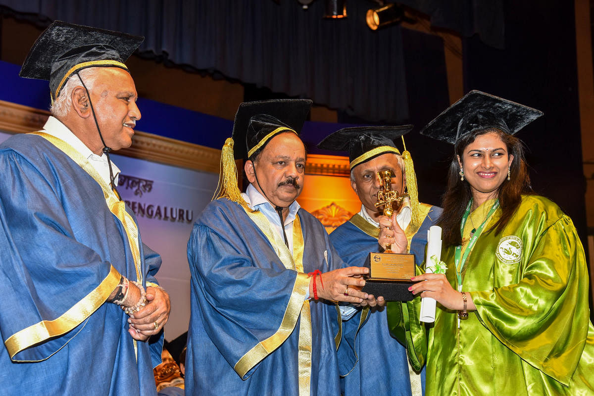Dr Harsh Vardhan, Union Minister for Health and Family Welfare presents the Best Outgoing Student in DM Neurology award to Dr K Neeraja at the 24th convocation of Nimhans in Bengaluru on Monday. Chief Minister B S Yediyurappa and Nimhans director Dr B N G