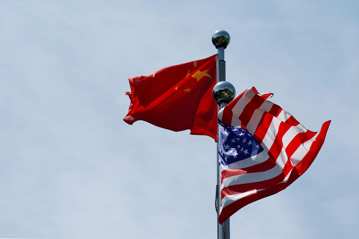 Chinese and U.S. flags flutter near The Bund, before U.S. trade delegation meet their Chinese counterparts for talks in Shanghai, China. (Photo by Reuters)