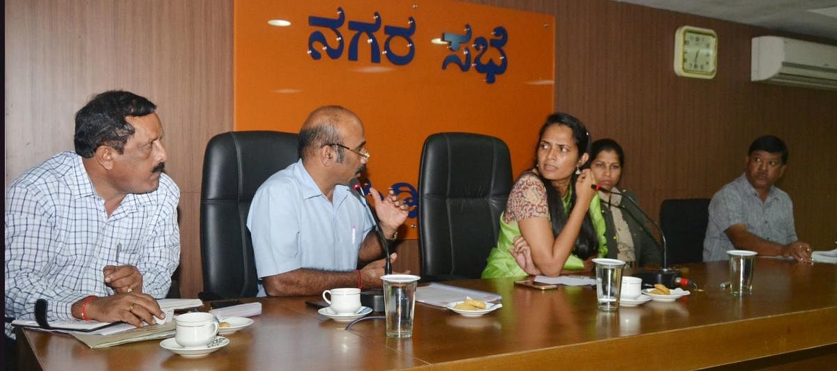 Deputy Commissioner Annies Kanmani Joy and Dasara Committee Working President Robin Devaiah discuss a point during a preparatory meeting in Madikeri.