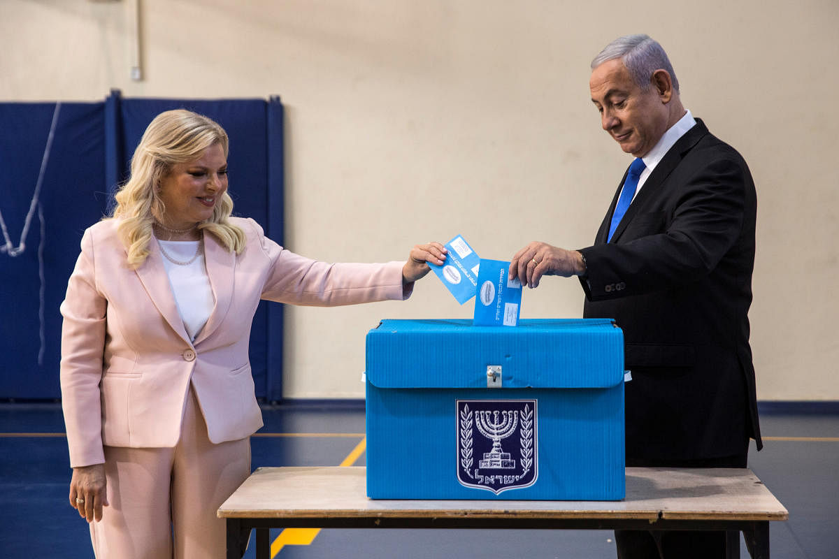 Israeli Prime Minister Benjamin Netanyahu and his wife Sara cast their vote during Israel's parliamentary election at a polling station in Jerusalem. (Reuters Photo)