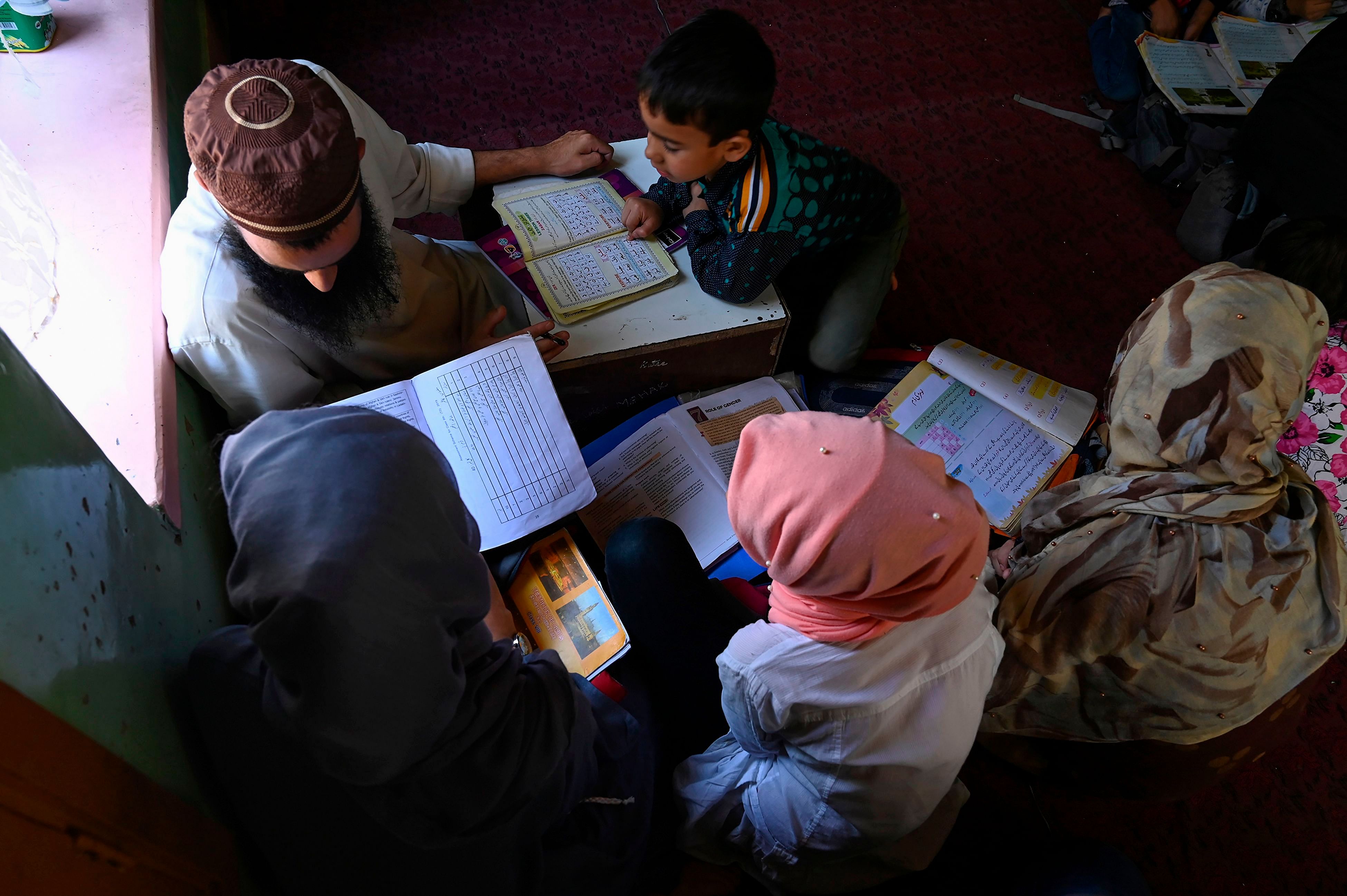 Kashmiri children study at a private home tuition centre during a lockdown on the outskirts of Srinagar. (AFP Photo)
