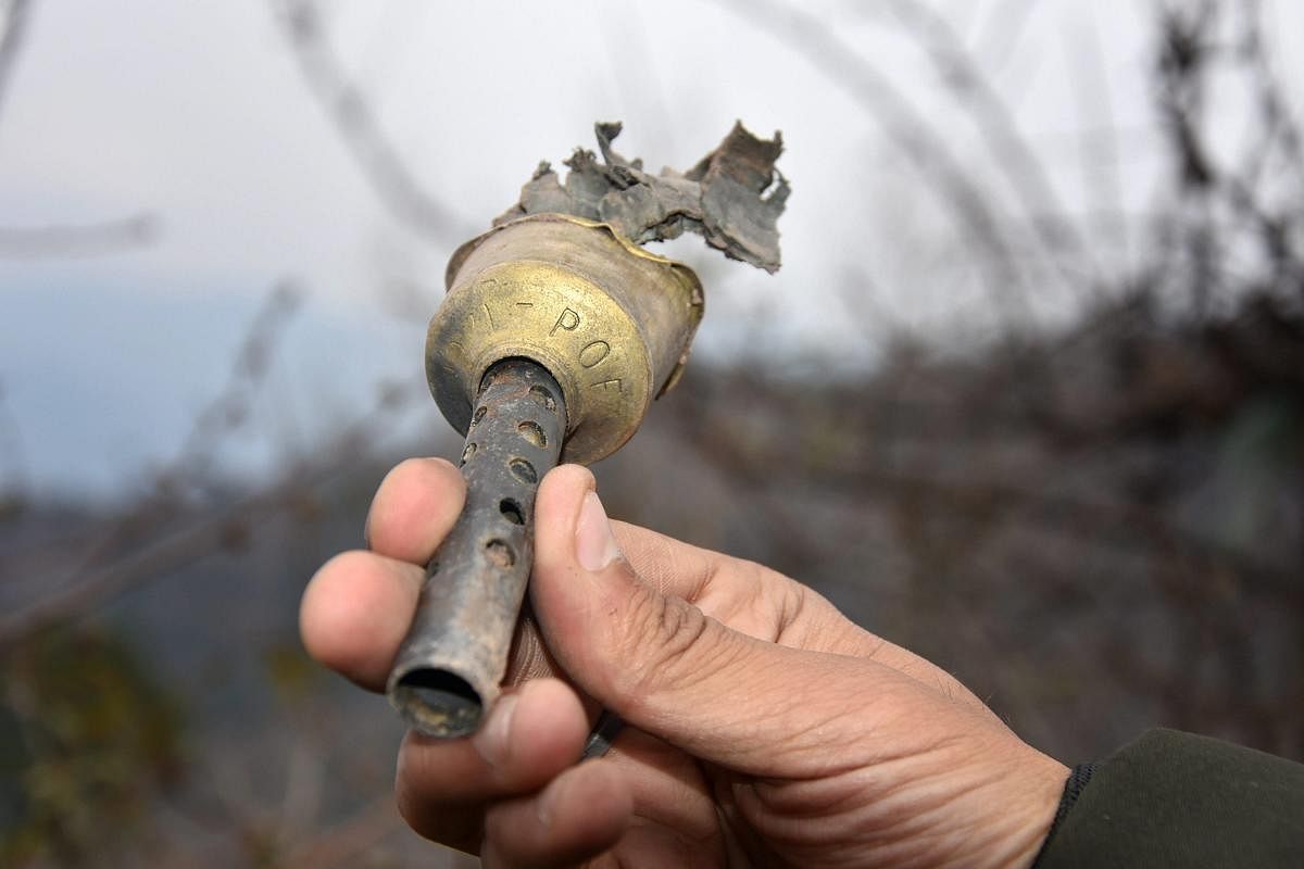 Poonch: A villager shows a part of a mortar shell fired from the Pakistani side at Mendhar in Poonch district. (PTI File Photo)