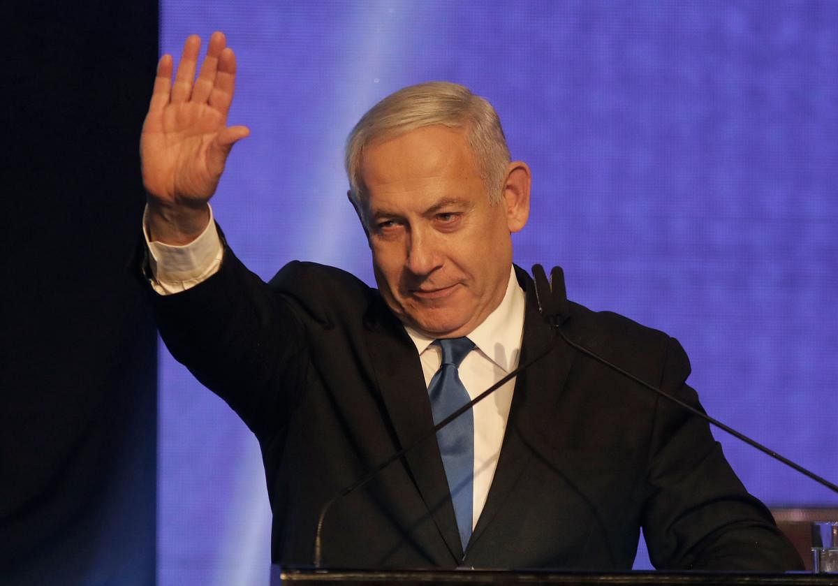 With a hoarse voice and appearing haggard after days of intense campaigning, Netanyahu appeared before supporters in the early hours of Wednesday and said he was prepared for negotiations to form a "strong Zionist government." (AFP Photo)