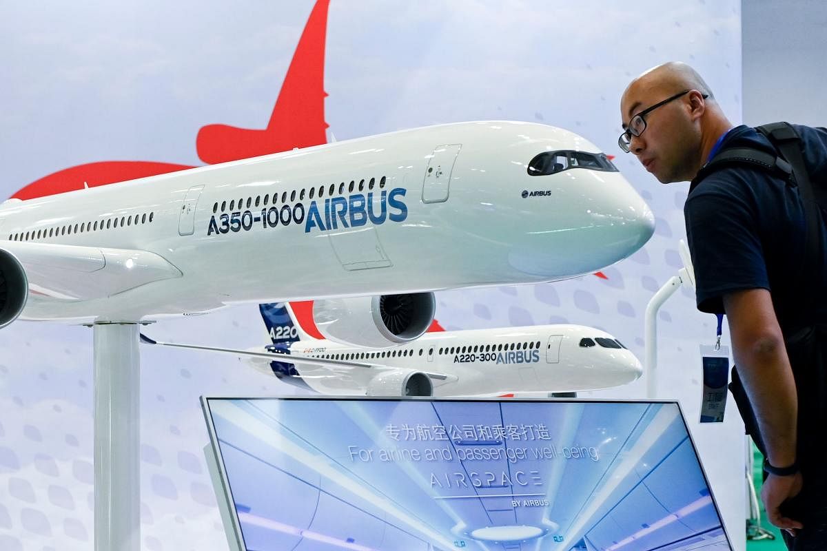 A visitor looks at an Airbus A350-1000 plane model at the Beijing International Aviation Expo in Beijing on September 18, 2019. Photo/AFP