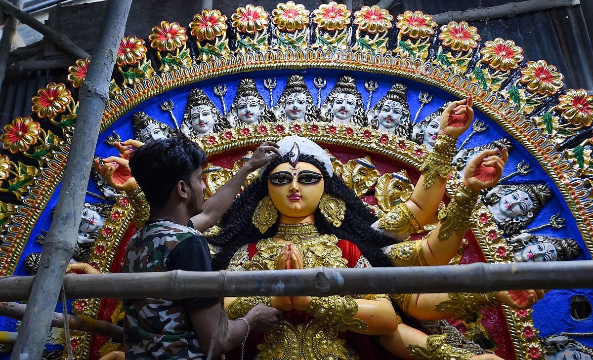 An artist gives finishing touches to an idol of Goddess Durga ahead of Durga Puja festival at Kumartuli in Kolkata, Wednesday, Sept. 18, 2019. (PTI Photo)