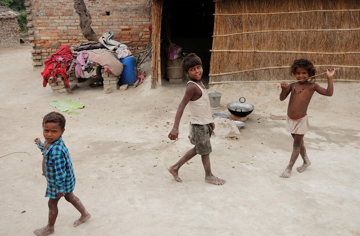 Children showing signs of malnutrition play outside their home in Marwan village in Bihar. REUTERS FILE