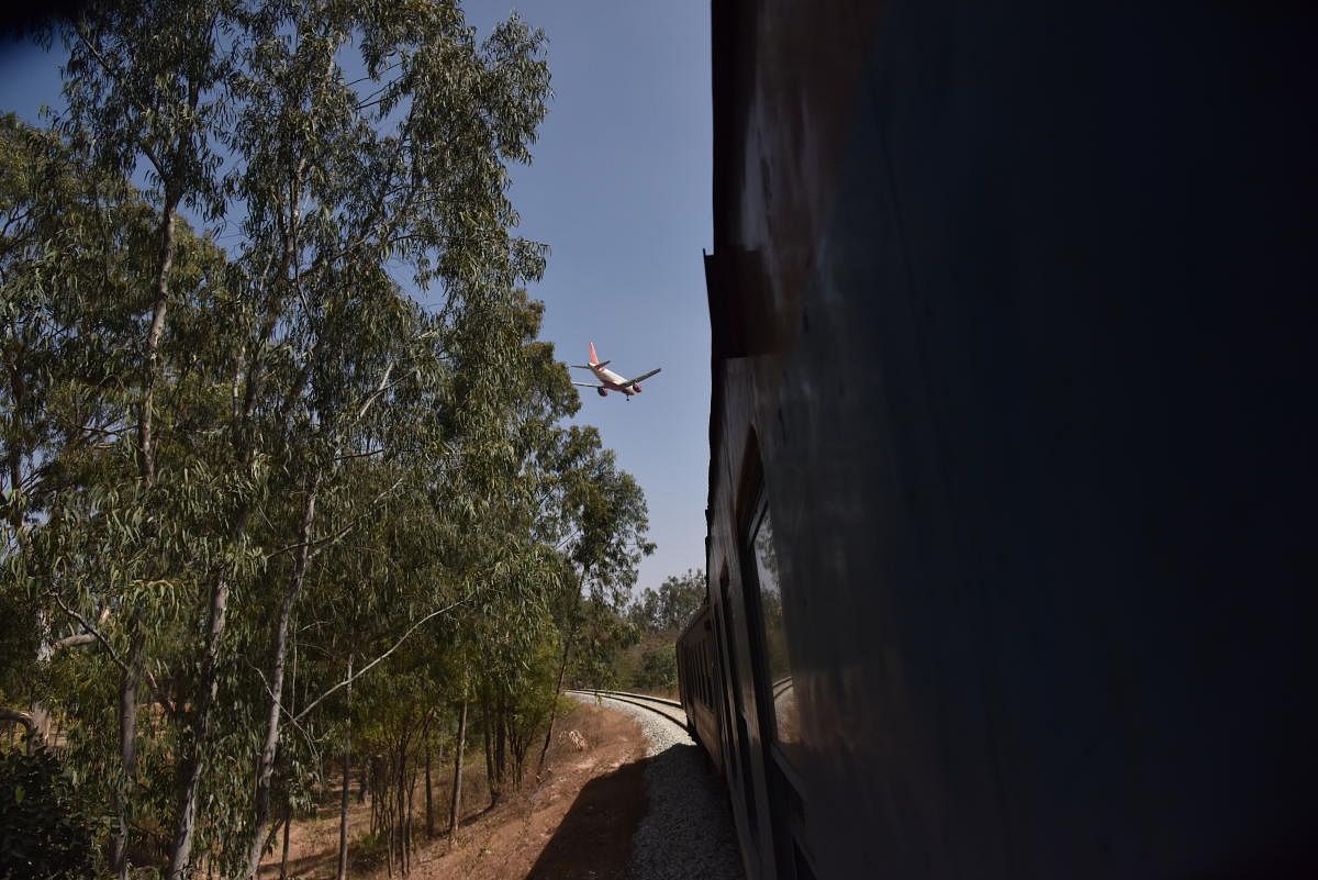 A DEMU train passes close to the airport periphery near the spot where a halt station is to come up. DH File/Shivakumar B H