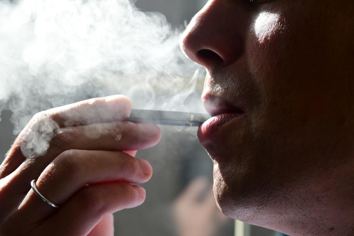 A man exhaling smoke from an electronic cigarette (AFP Photo)
