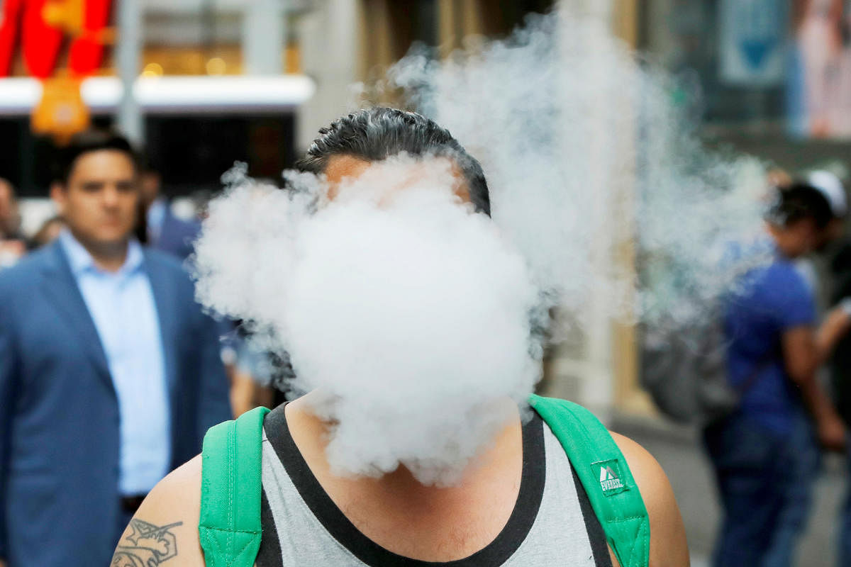 A man uses a vape as he walks on Broadway in New York City, U.S (Reuters photo)