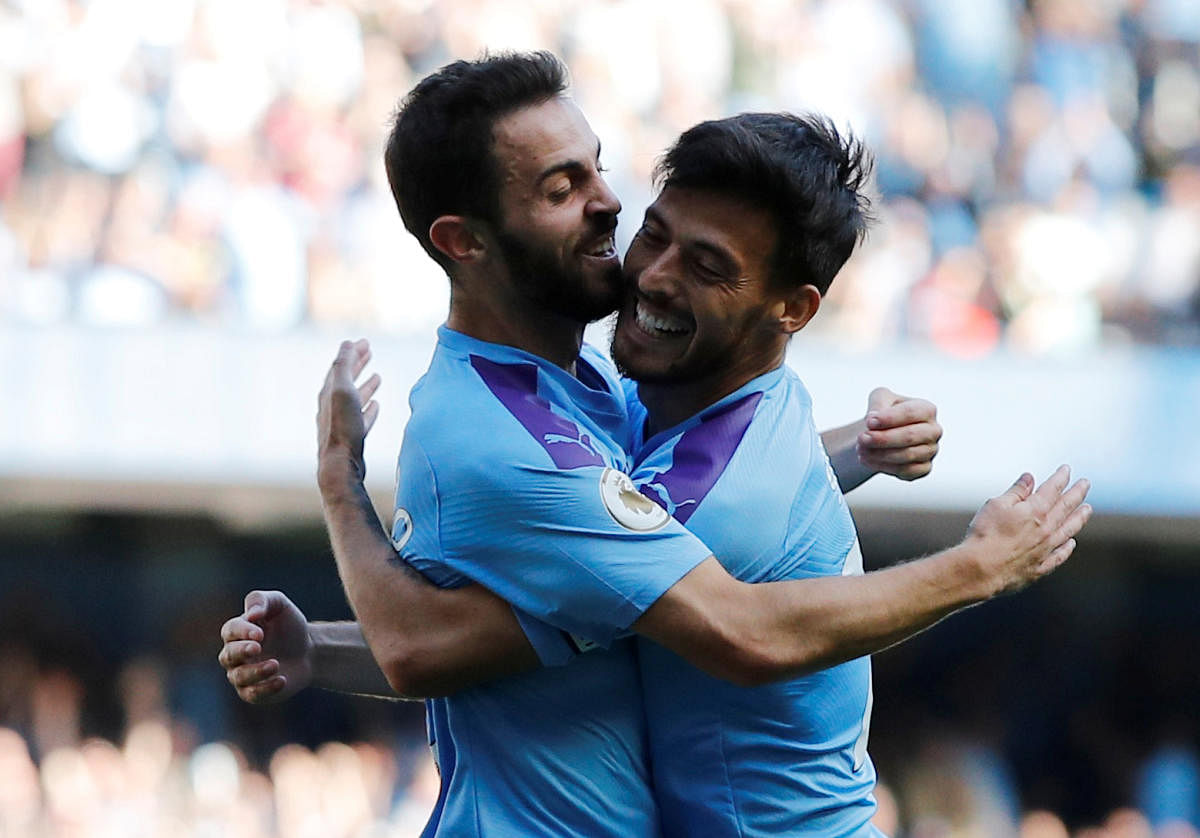 Manchester City's Bernardo Silva celebrates scoring their sixth goal with teammate David Silva. Photo credit: Reuters