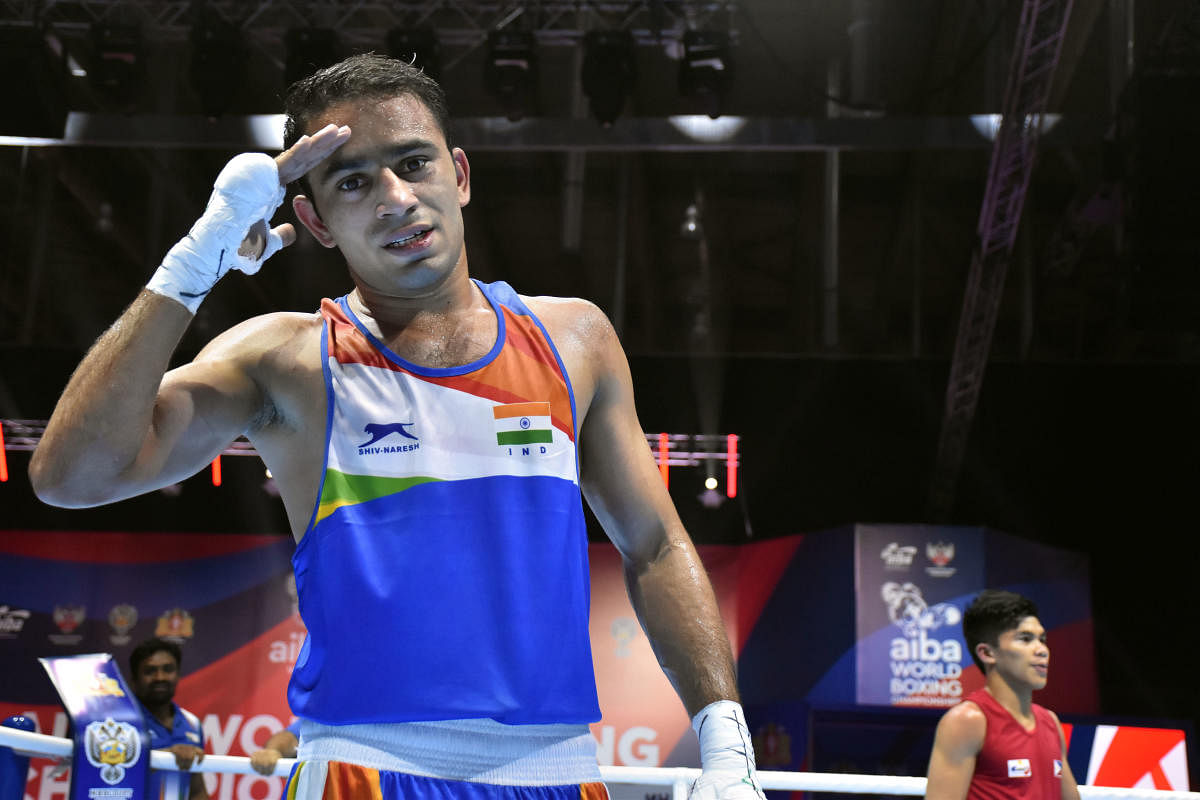 India's Amit Panghal poses for photographs after winning the quarterfinal bout of 51kg category (PTI Photo)