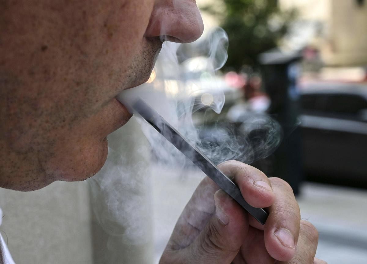 One theory is that vaping chemicals may impair the immune system, and make people who vape more vulnerable to respiratory distress. Photo/AFP