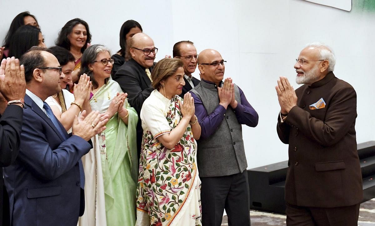 Prime Minister Narendra Modi exchanges greetings with a delegation of Kashmiri Pandits during an interaction with the Indian community in Houston, Texas, USA, Saturday, Sept. 21, 2019. (PIB/PTI Photo)