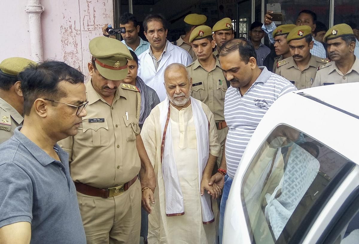 Former Union minister Swami Chinmayanand, accused of rape by a law student, is seen outside a government hospital after a medical examination following his arrest by a special team of Uttar Pradesh police. PTI
