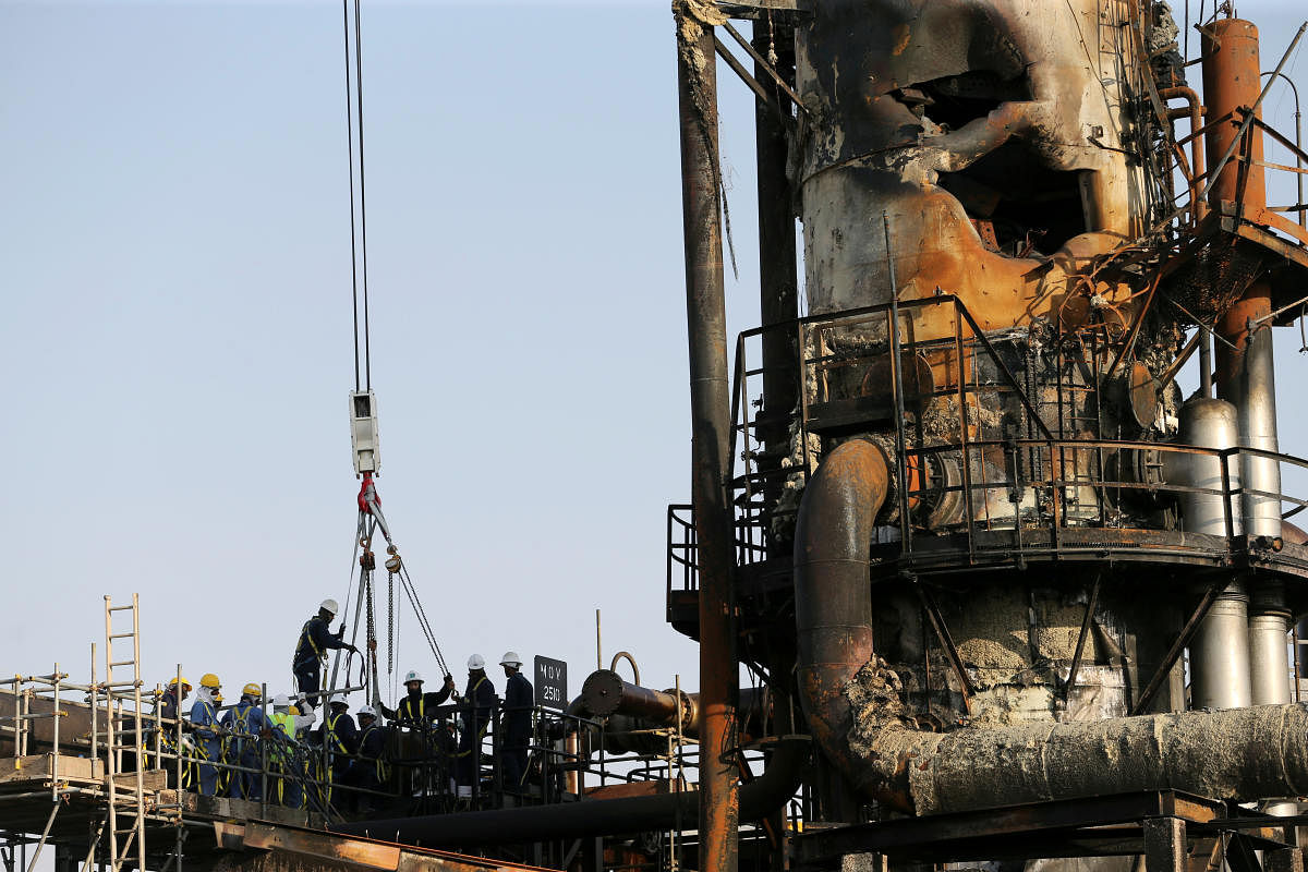 Workers are seen at the damaged site of Saudi Aramco oil facility in Abqaiq, Saudi Arabia. Reuters File Photo