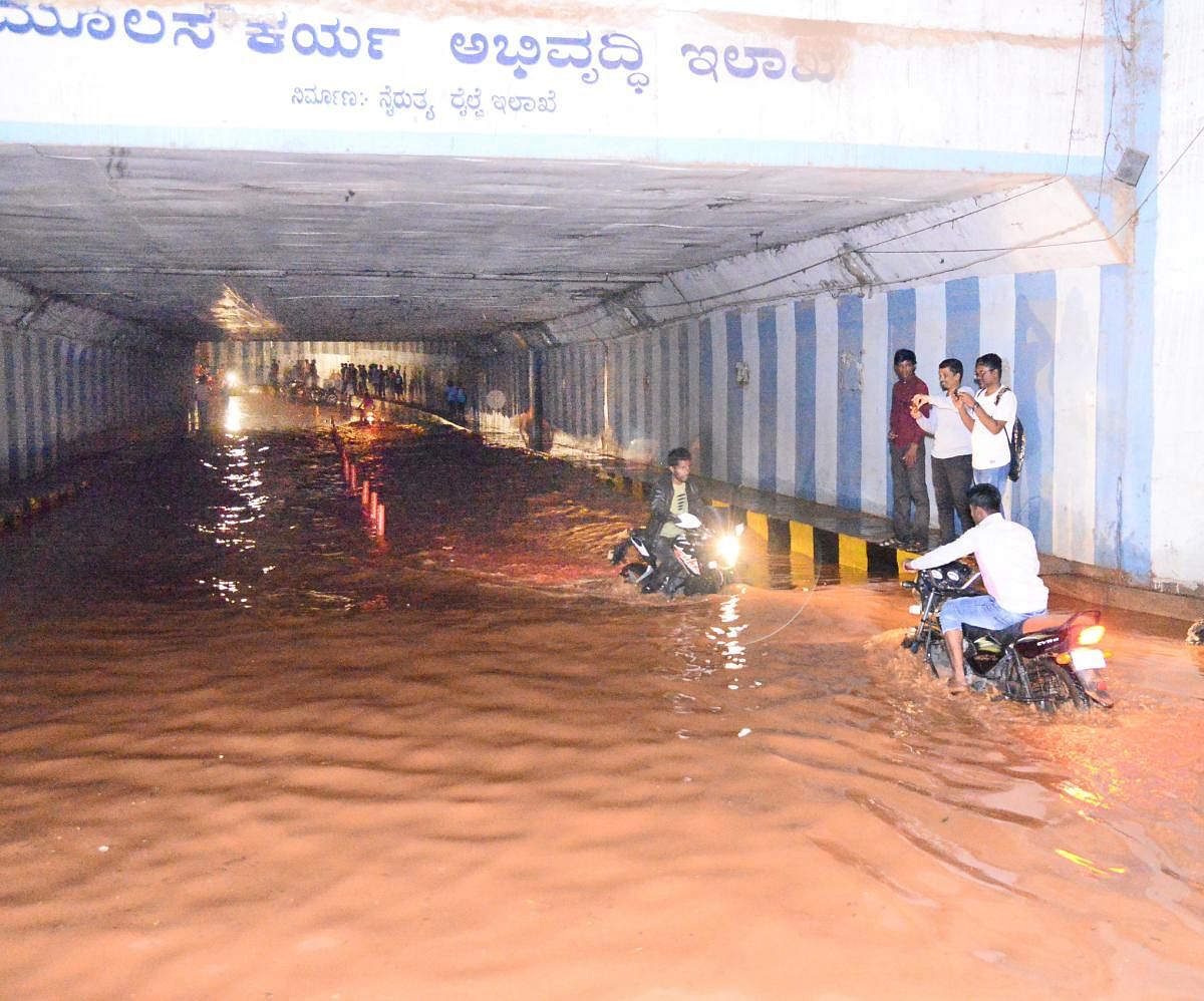 Motorists navigate through the flooded Shettihalli Underpass in Tumakuru on Monday. The city witnessed heavy showers since Sunday night.
