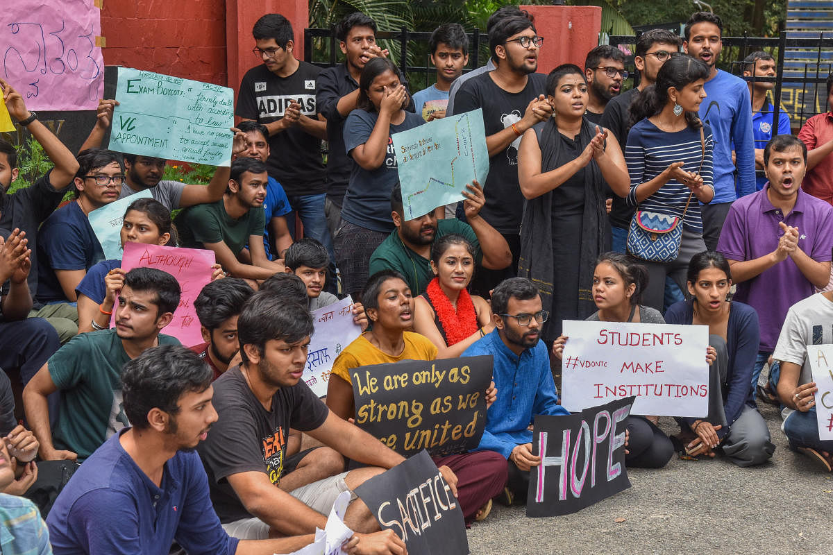 Students of the National Law School of India University stage a protest on Monday, demanding the immediate appointment of the vice-chancellor. DH PHOTO/S K Dinesh