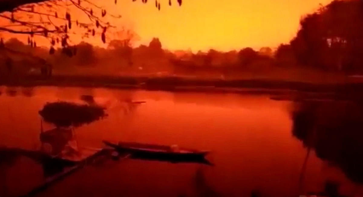 A glowing red sky is seen in Kumpeh District in Muaro Jambi Regency, Indonesia in this still image obtained from a September 21. (Instagram/@DANI_KHOLIK via Reuters)