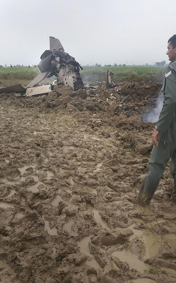 An Indian Air Force official inspect the site where MiG-21 trainer jet crashed near the Gwalior airbase, Wednesday, Sept. 25, 2019. The aircraft, which was on a routine mission, crashed around 10 am. (PTI Photo) 