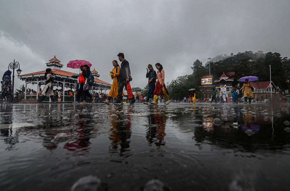 People take a stroll at the ridge after rainfall, in Shimla, Friday, Sept. 20, 2019. (PTI Photo)