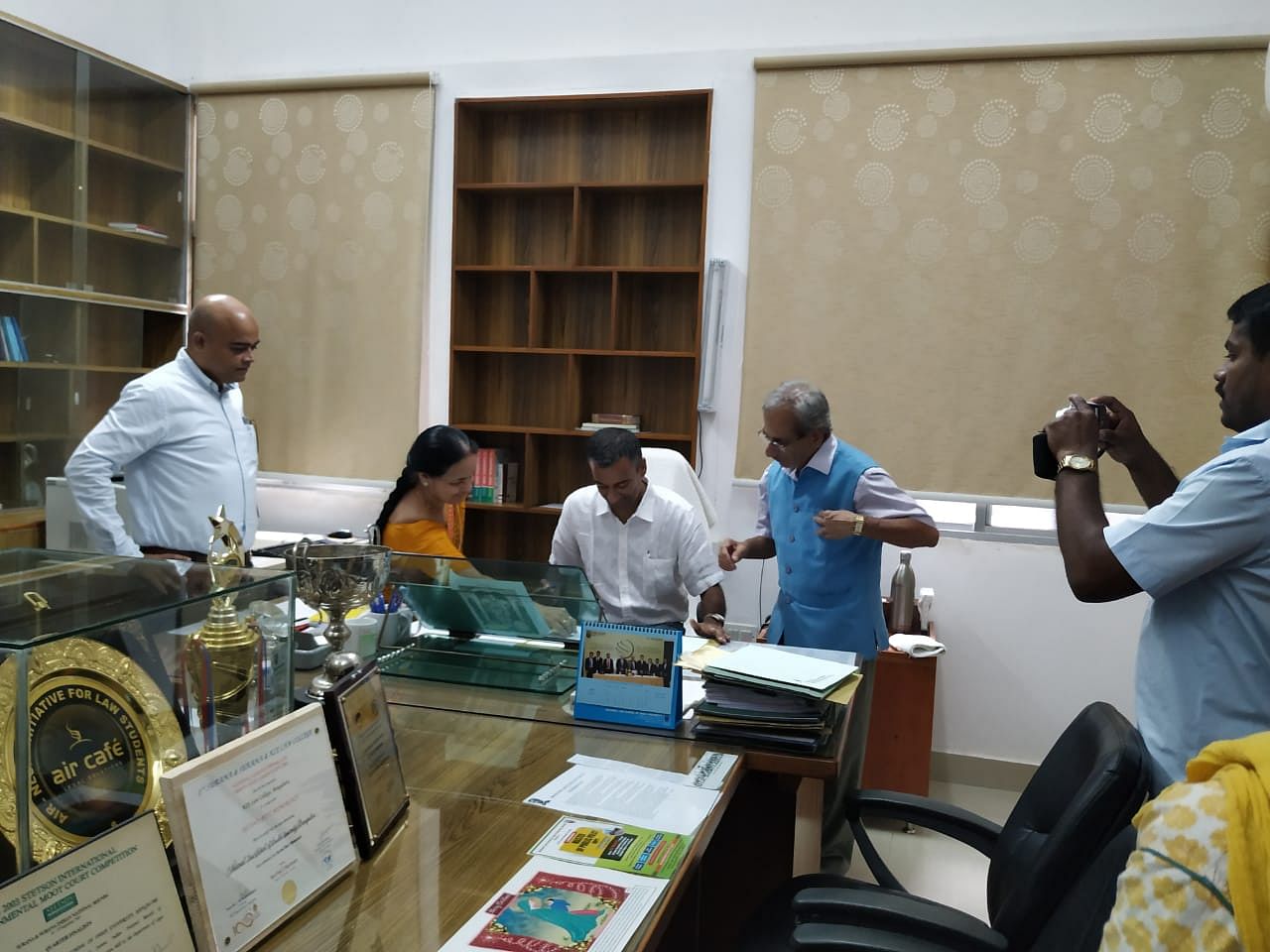 Prof. Krishnaswamy signs documents formalizing his appointment as VC of NLSIU.