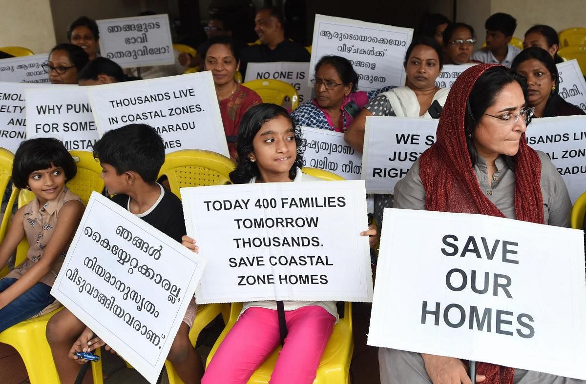 Residents of various flats at Maradu, which have been ordered to be demolished by the Supreme Court, stage a protest in front of Holy Faith apartment, in Kochi, Sunday, Sept. 15, 2019. The Supreme Court had on Sept. 6 ordered the demolition of illegal flats in Kochi's Maradu Panchayat by Sept. 20 for violation of Coastal Regulation Zone (CRZ) rules. (PTI Photo)