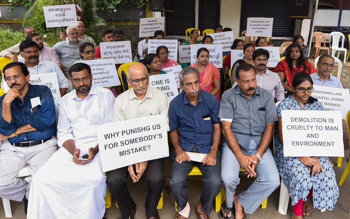 Ernakulam: Residents of the various flats at Maradu, which have been ordered to be demolished by the Supreme Court, stage a protest outside the Maradu municipality office, Ernakulam district. (PTI Photo)