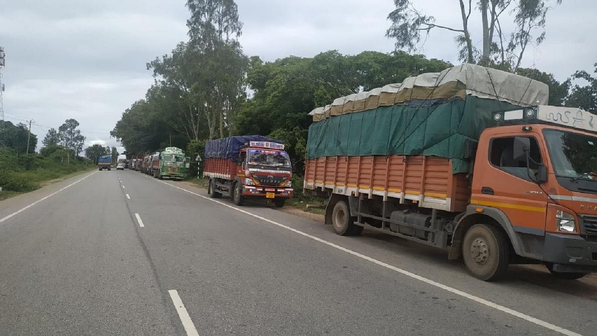 Trucks bound for Kerala lined up on the road near Madduru checkpost, Gundlupet taluk of Chamarajanagar district on Thursday.