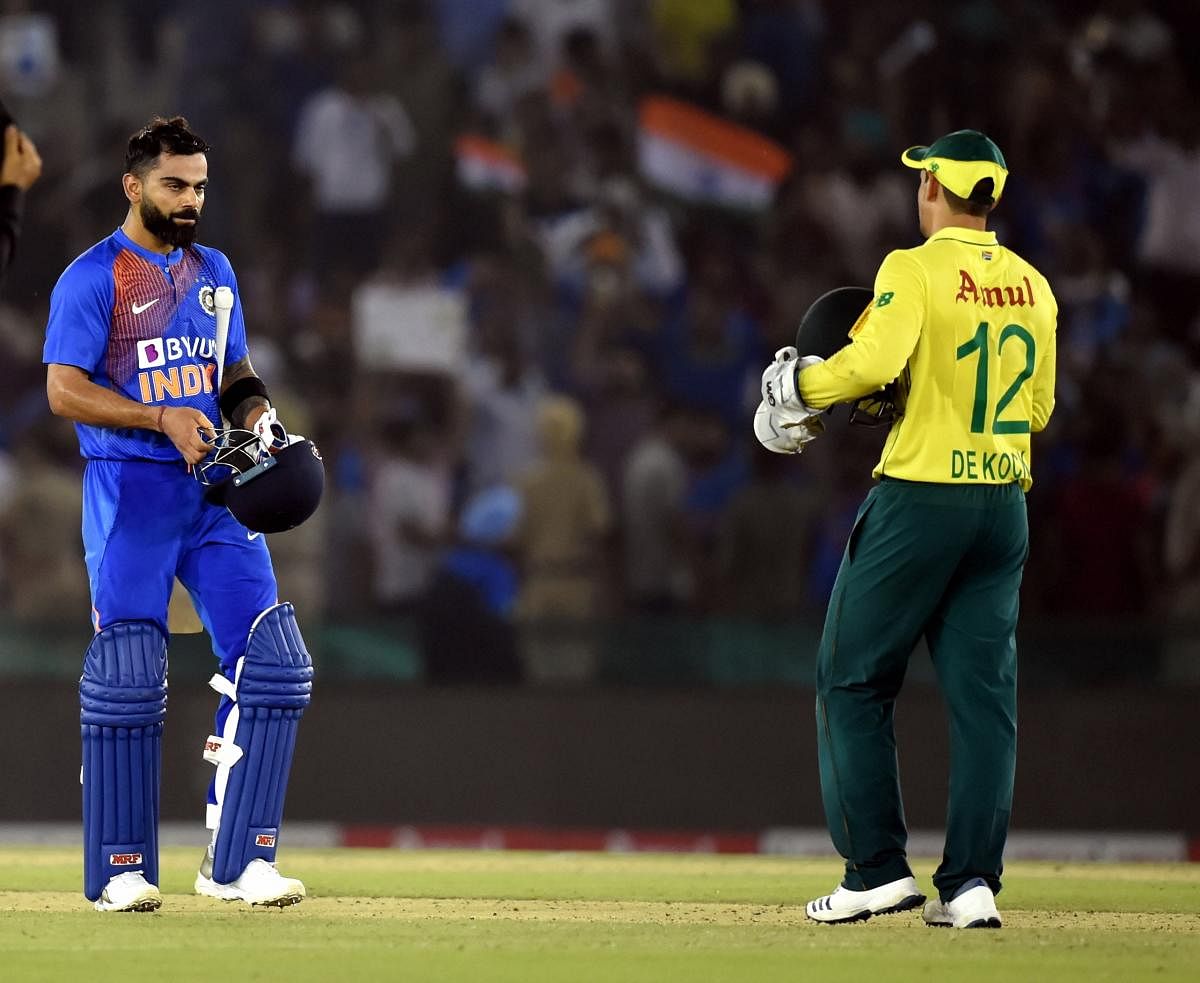 Mohali: Indian captain Virat Kohli after winning the 2nd T-20 match as South African captain Quinton de Kock looks on, in Mohali. (PTI Photo)