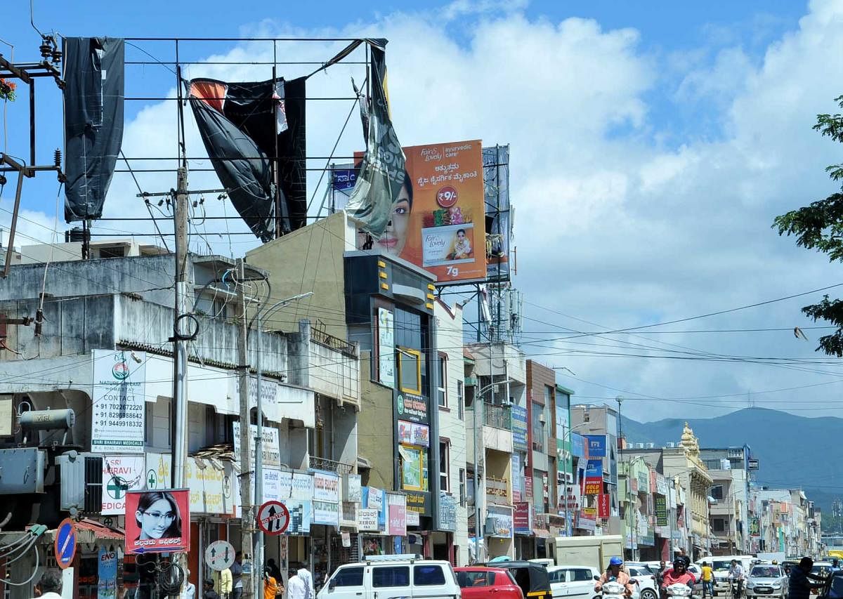 The torn and worn out hoardings on the top of a building on M G Road in Chikkamagaluru.