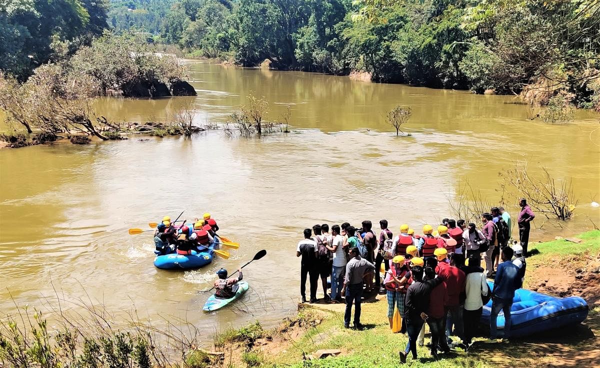 Youth enjoy free river rafting organised on account of World Tourism Day at Balehole in Kalasa on Friday.