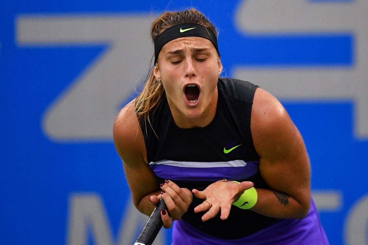 Aryna Sabalenka of Belarus reacts after a point against Ashleigh Barty of Australia during their women's singles semi-final match at the Wuhan Open tennis tournament in Wuhan on September 27, 2019. (AFP)