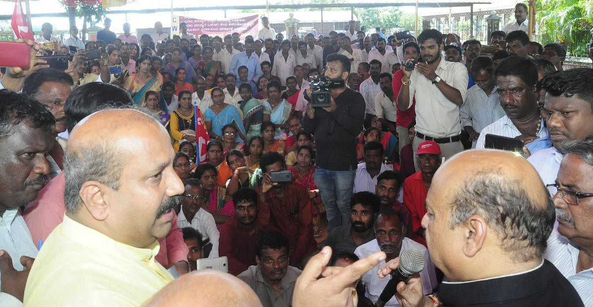 Home Minister Basavaraj Bommai addresses CITU protesters, who were staging protest demanding resuming of sand extraction, in front of DC's office in Manipal on Friday.