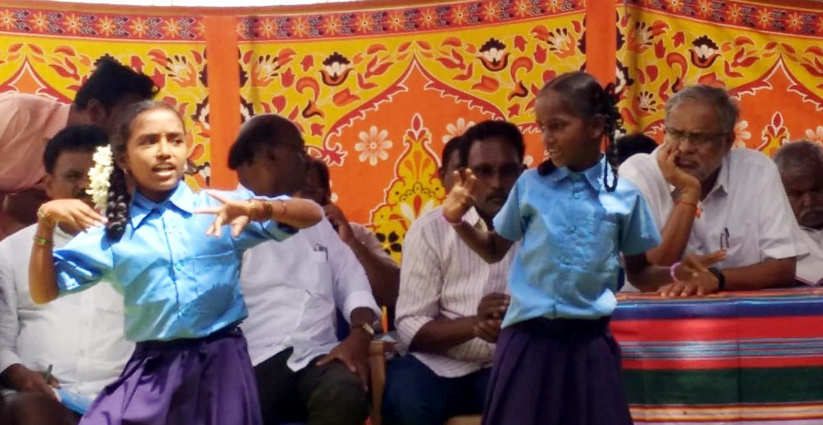 Minister for Primary and Secondary Education Suresh Kumar watches a dance performance as part of cultural programme at higher primary school at Kyathaganacharlu in Pavagada taluk. DH Photo