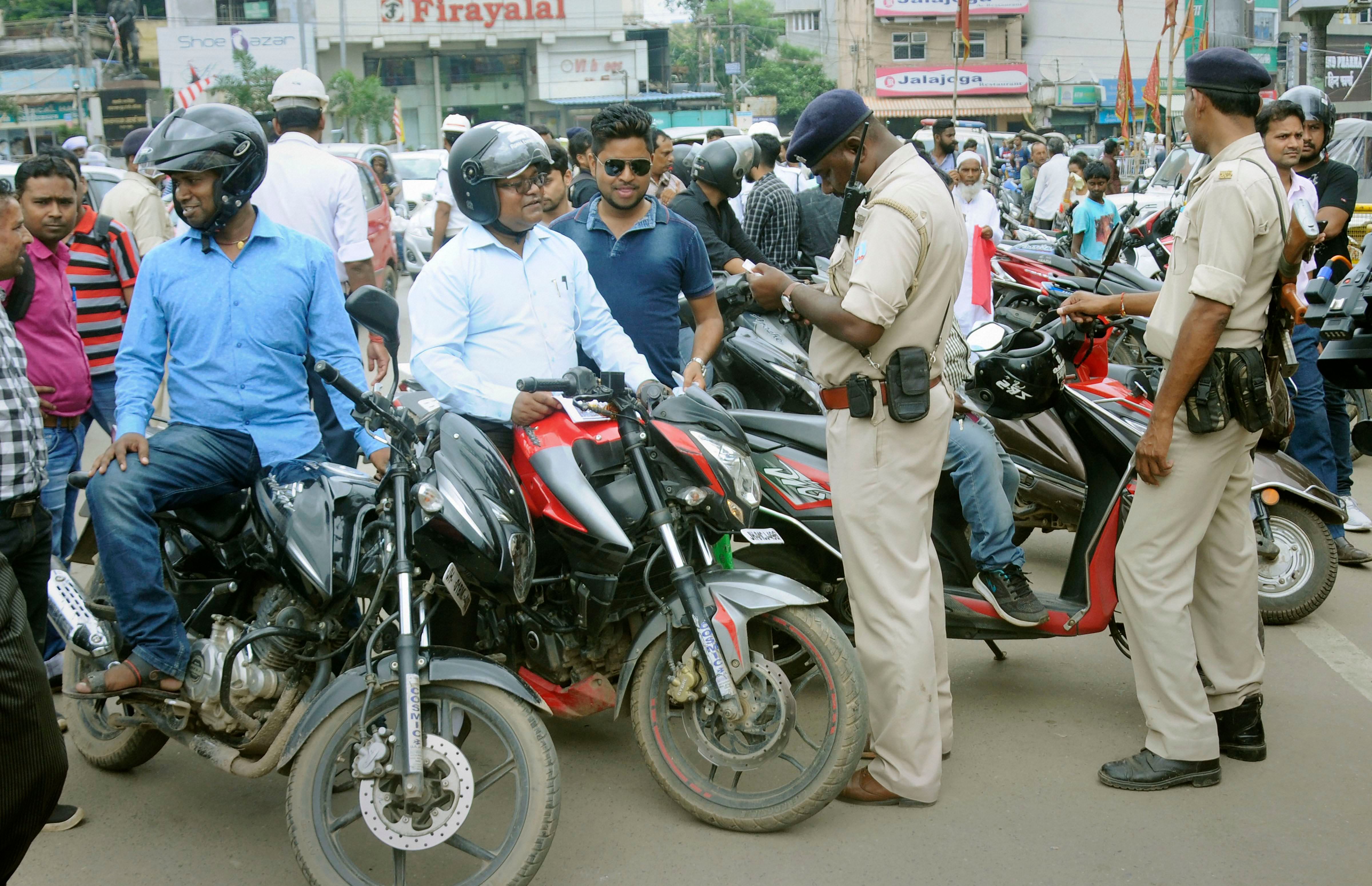 District traffic police personnel impose penalty on traffic offenders. (PTI Photo)