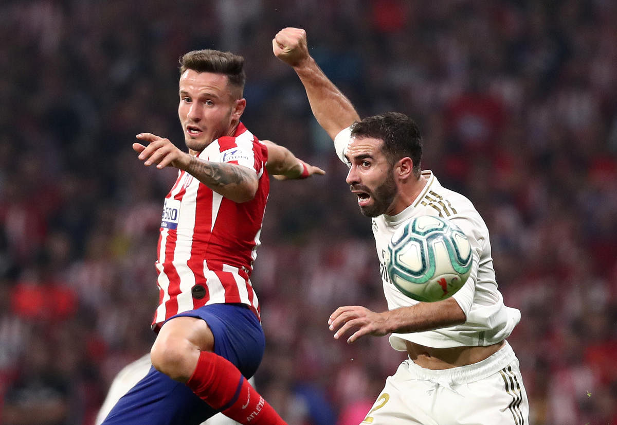  Real Madrid's Dani Carvajal in action with Atletico Madrid's Saul Niguez. Photo/REUTERS
