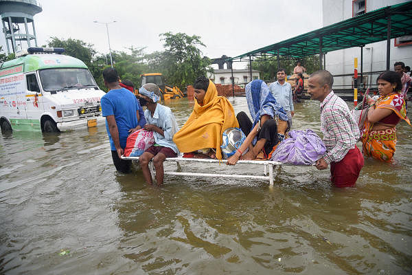 Patna: Patients being shifted from flooded Nalanda Medical College and Hospital (NMCH), after heavy monsoon rains in Patna. (Photo: PTI)