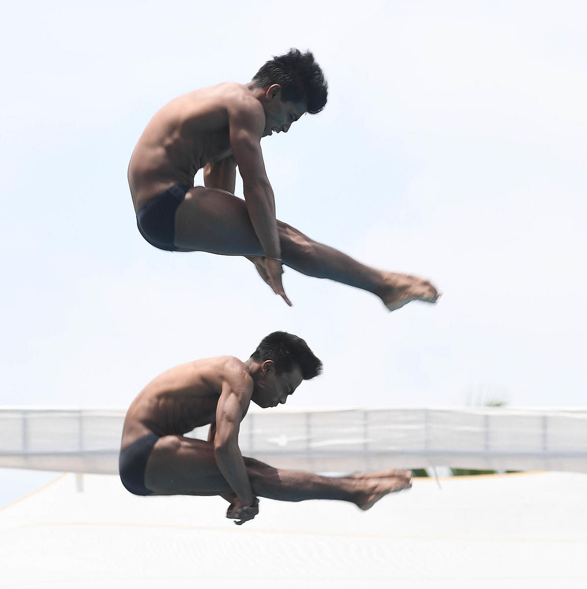 Indian divers Satish Kumar Parjapati and N Wilon Singh in action during the 3m synchronised diving event in the 10th Asian Age Group Swimming Championship 2019 at SAI sports complex on Sunday. DH Photo/ Srikanta Sharma R.