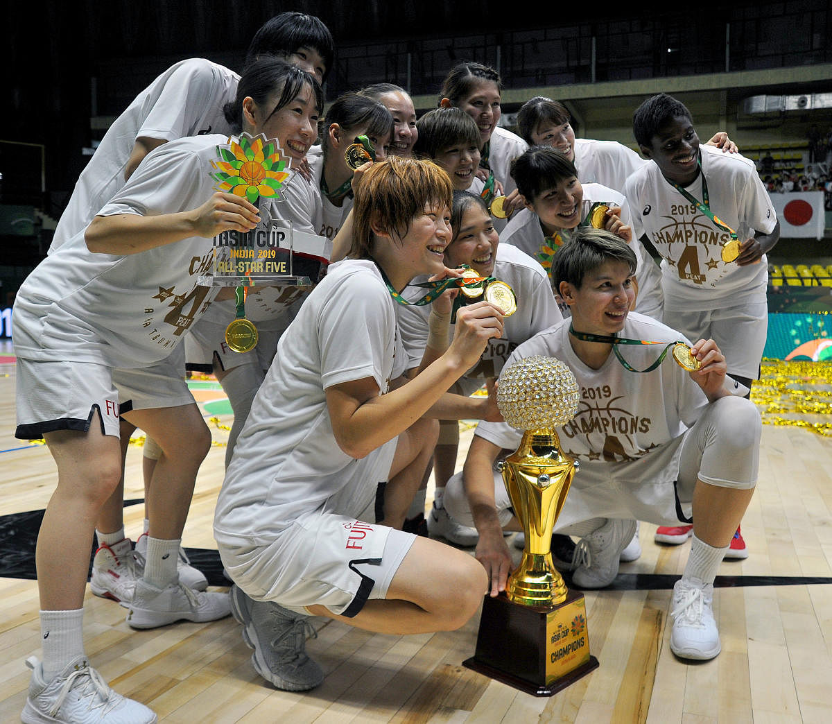 Japan team celebrate after winning the FIBA Women's Asia Cup in Bengaluru on Sunday. DH Photo/ Pushkar V