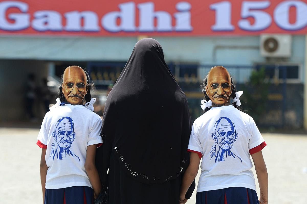 School children wear masks of Mahatma Gandhi at a school in Chennai. (AFP Photo)