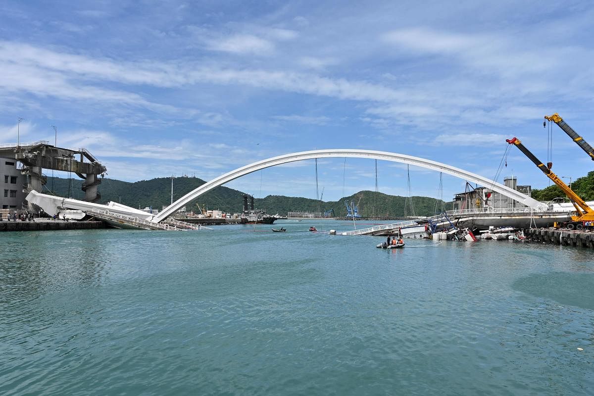 This general view shows a bridge after it collapsed in the Nanfangao fish harbour in Suao township on October 1, 2019. (Photo by Sam YEH / AFP)