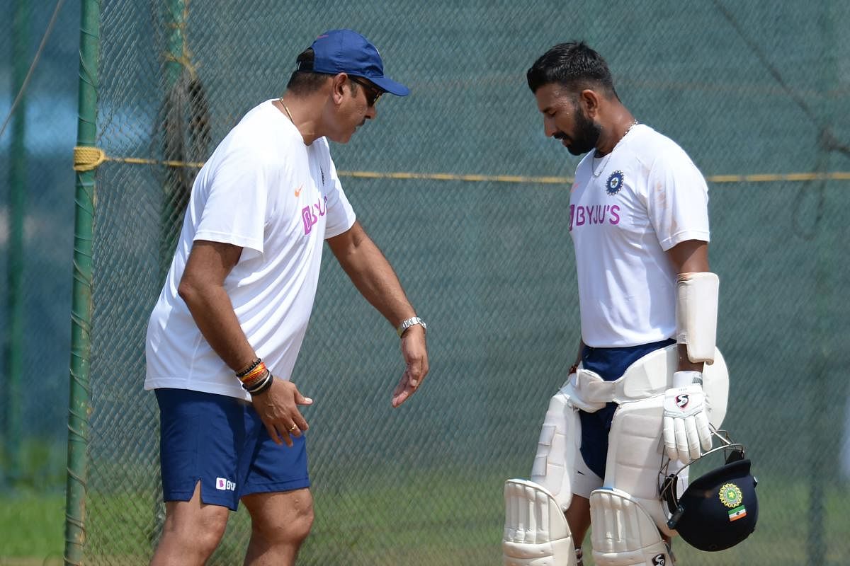 India’s Head Coach Ravi Shastri (left) demonstrates a finer point to Cheteshwar Pujara during a practice session in Visakhapatnam on Tuesday. AFP