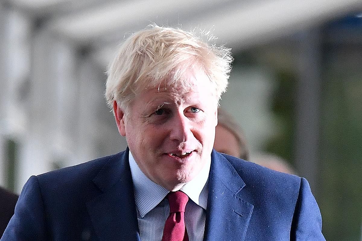 Britain's Prime Minister Boris Johnson returns to his hotel after giving media interviews ahead of the third day of the annual Conservative Party conference in Manchester, north-west England on October 1, 2019. (AFP)