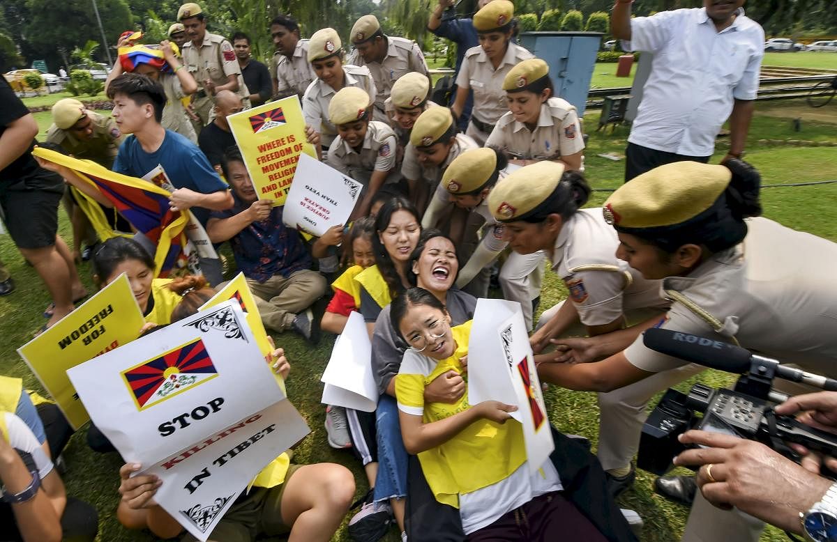 Police personnel detain Tibetan Youth Congress activists during a protest near the Chinese embassy, in New Delhi. PTI Photo