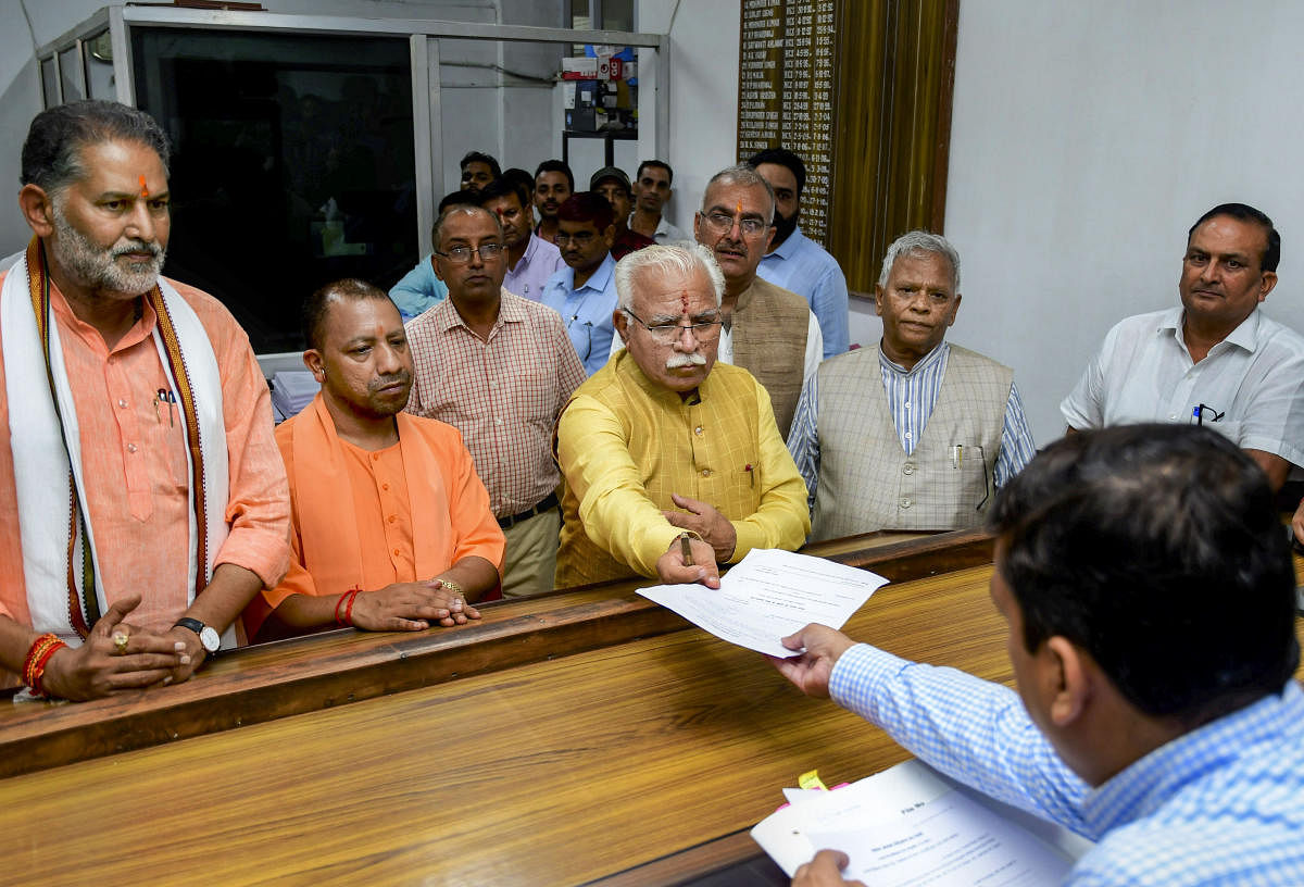 Haryana Chief Minister Manohar Lal Khattar files nominations from Karnal assembly seat at SDM Office, in Karnal, Tuesday, Oct. 1, 2019. Uttar Pradesh Chief Minister Yogi Adityanath and Union Minister Rattan Lal Kataria are also seen. (PTI Photo)