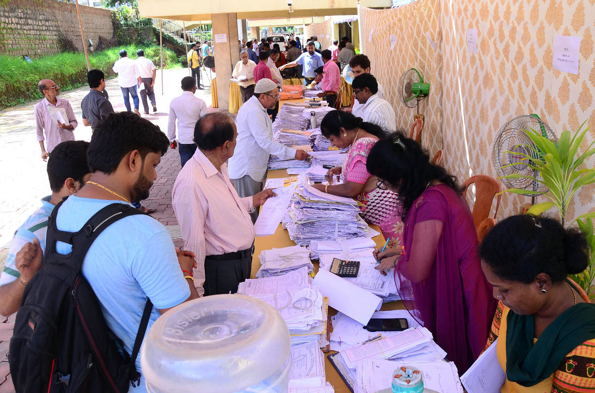 Traders submitting applications at the trade license adalat organised at Mangaluru City Corporation in Mangaluru on Tuesday.