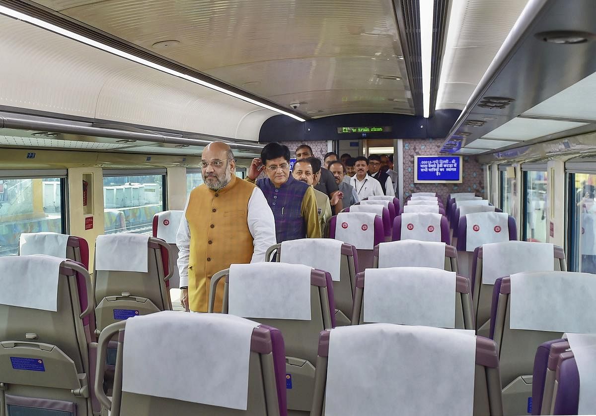 Union Home Minister Amit Shah inside a coach of the semi -high-speed train Vande Bharat Express before its flags off ceremony at New Delhi Railway Station, in New Delhi on Thursday. (PTI Photo)